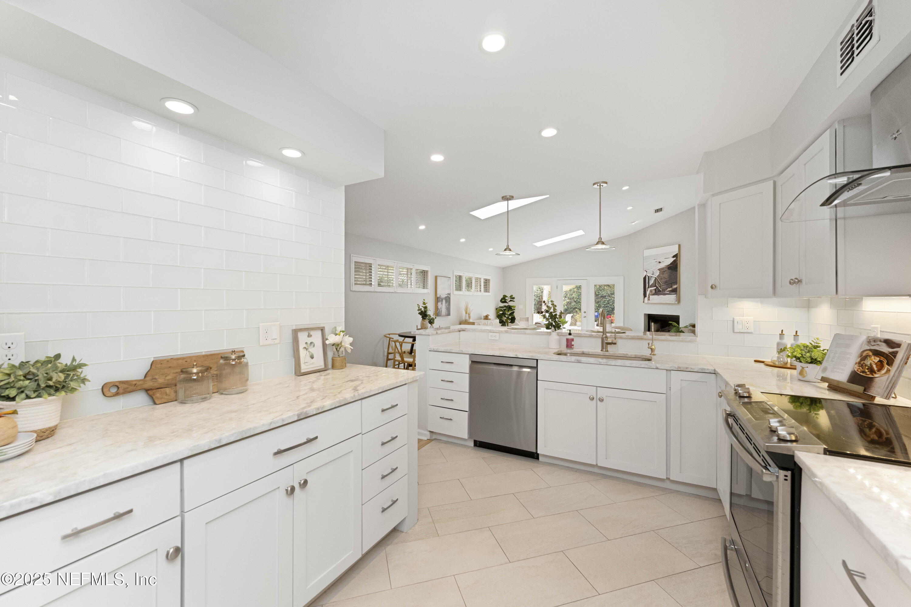 372 4th Street Atlantic Beach, FL 32233 - Photo 13 of 77 a kitchen with sink and white cabinets