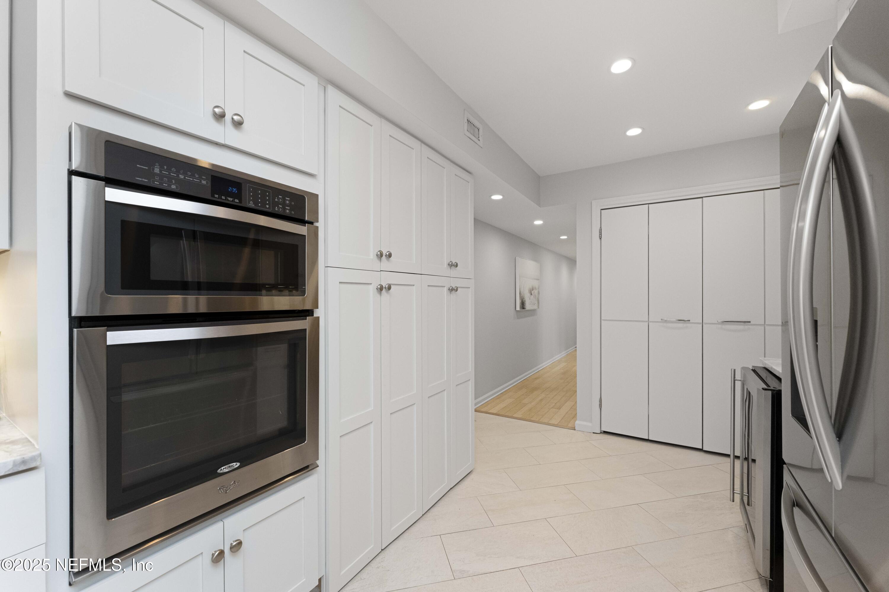 372 4th Street Atlantic Beach, FL 32233 - Photo 14 of 77 a kitchen with granite countertop white cabinets stainless steel appliances and a counter space