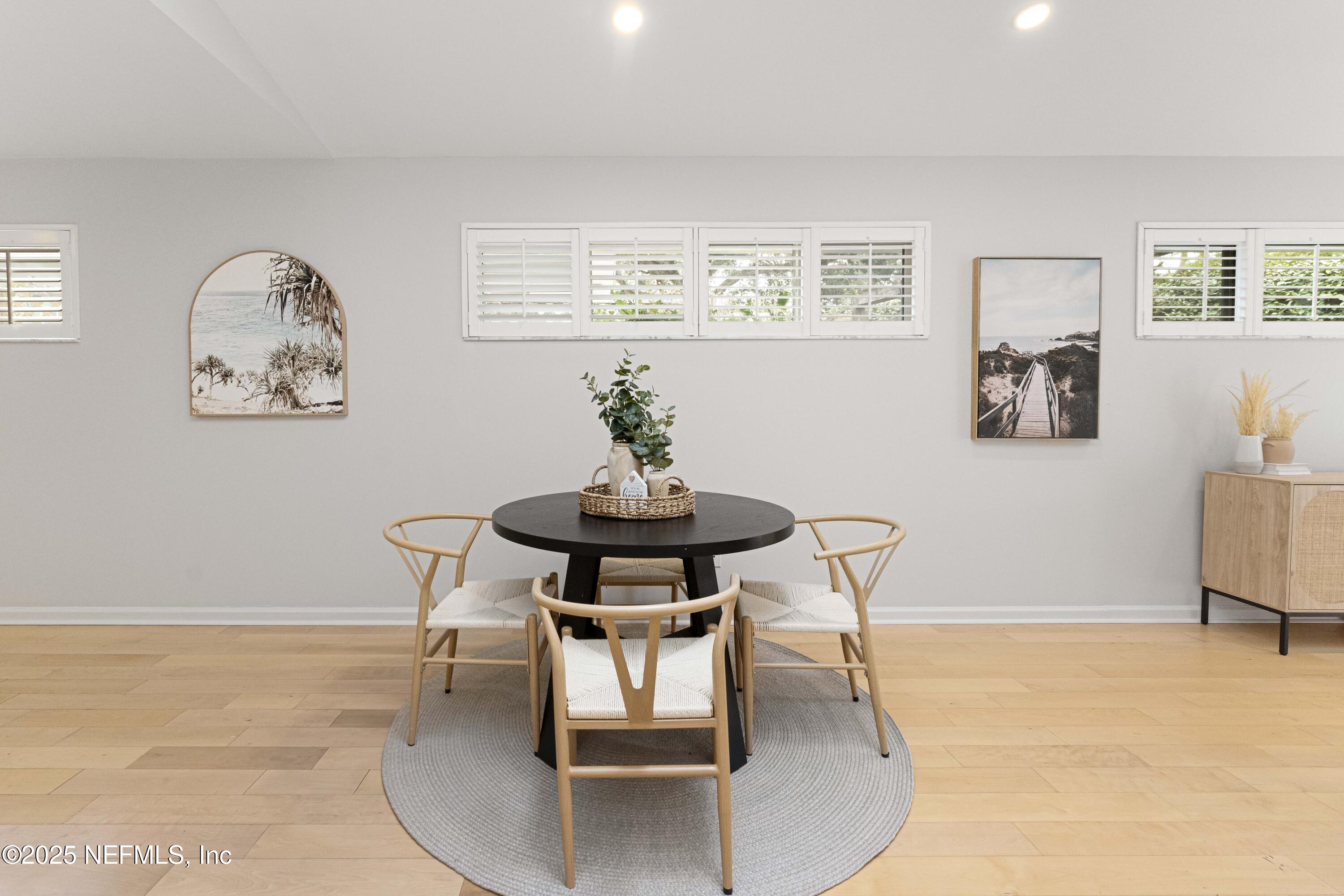 372 4th Street Atlantic Beach, FL 32233 - Photo 17 of 77 a dining room with wooden floor and a chandelier