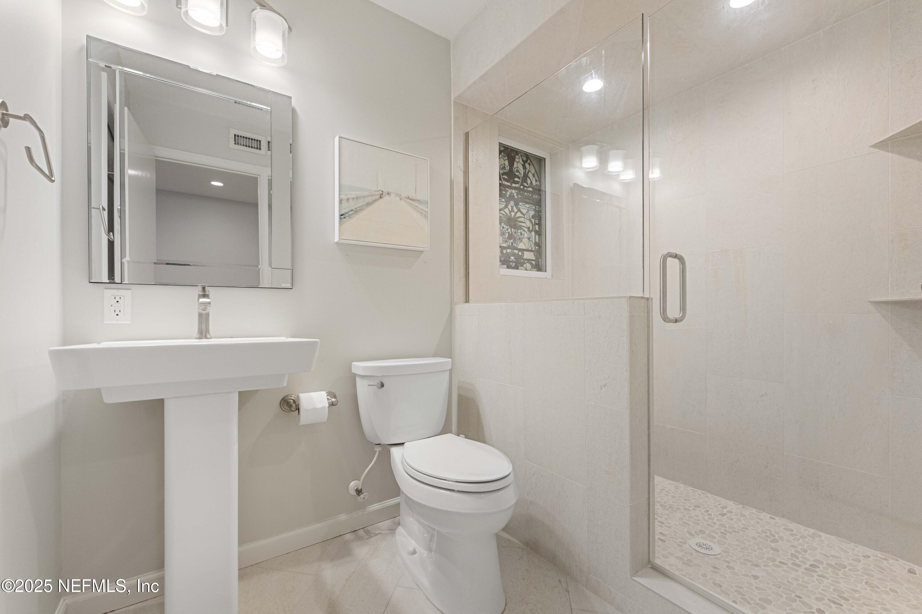 372 4th Street Atlantic Beach, FL 32233 - Photo 23 of 77 a bathroom with a toilet sink and shower