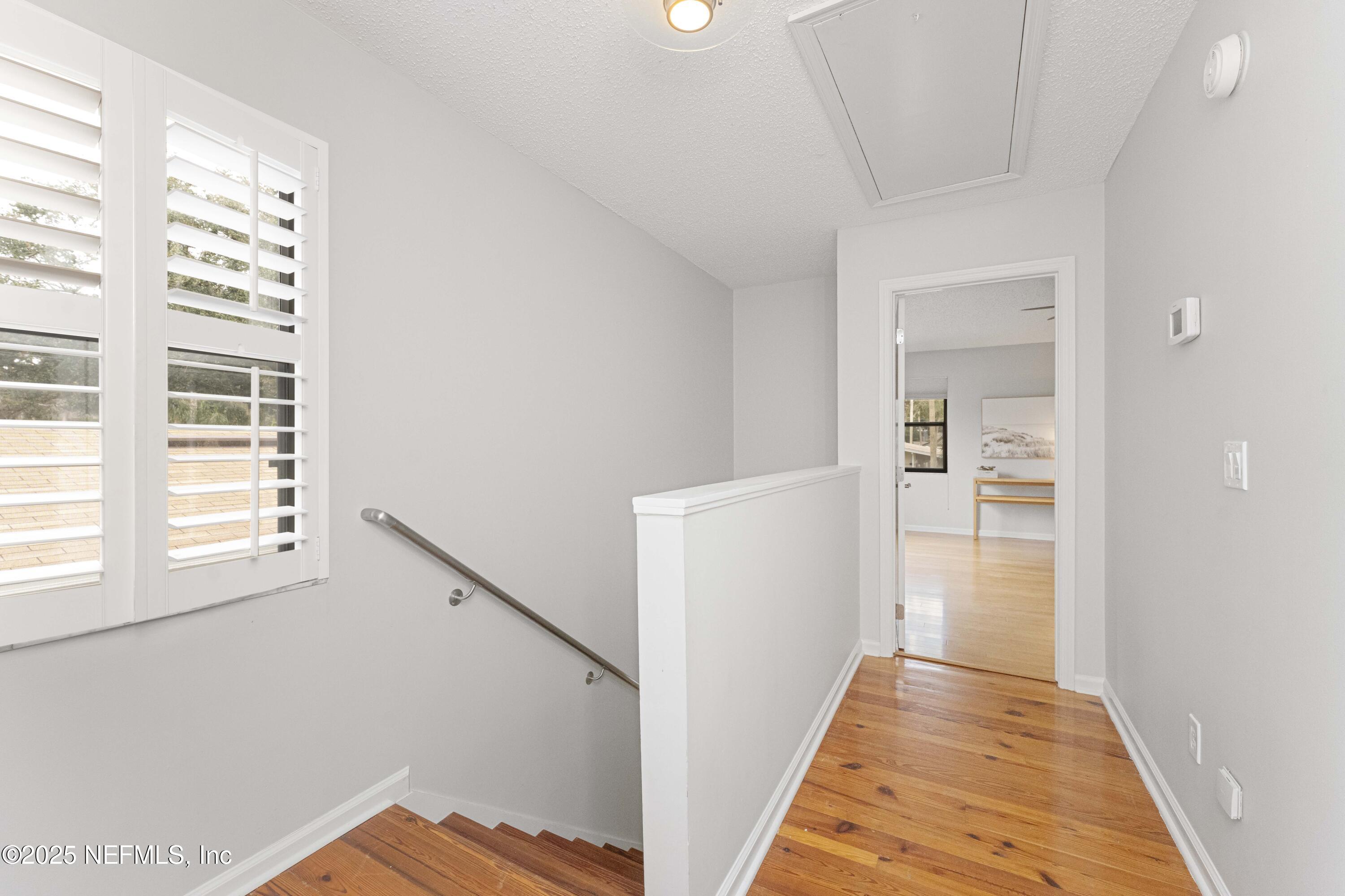 372 4th Street Atlantic Beach, FL 32233 - Photo 25 of 77 a view of a hallway with wooden floor and staircase