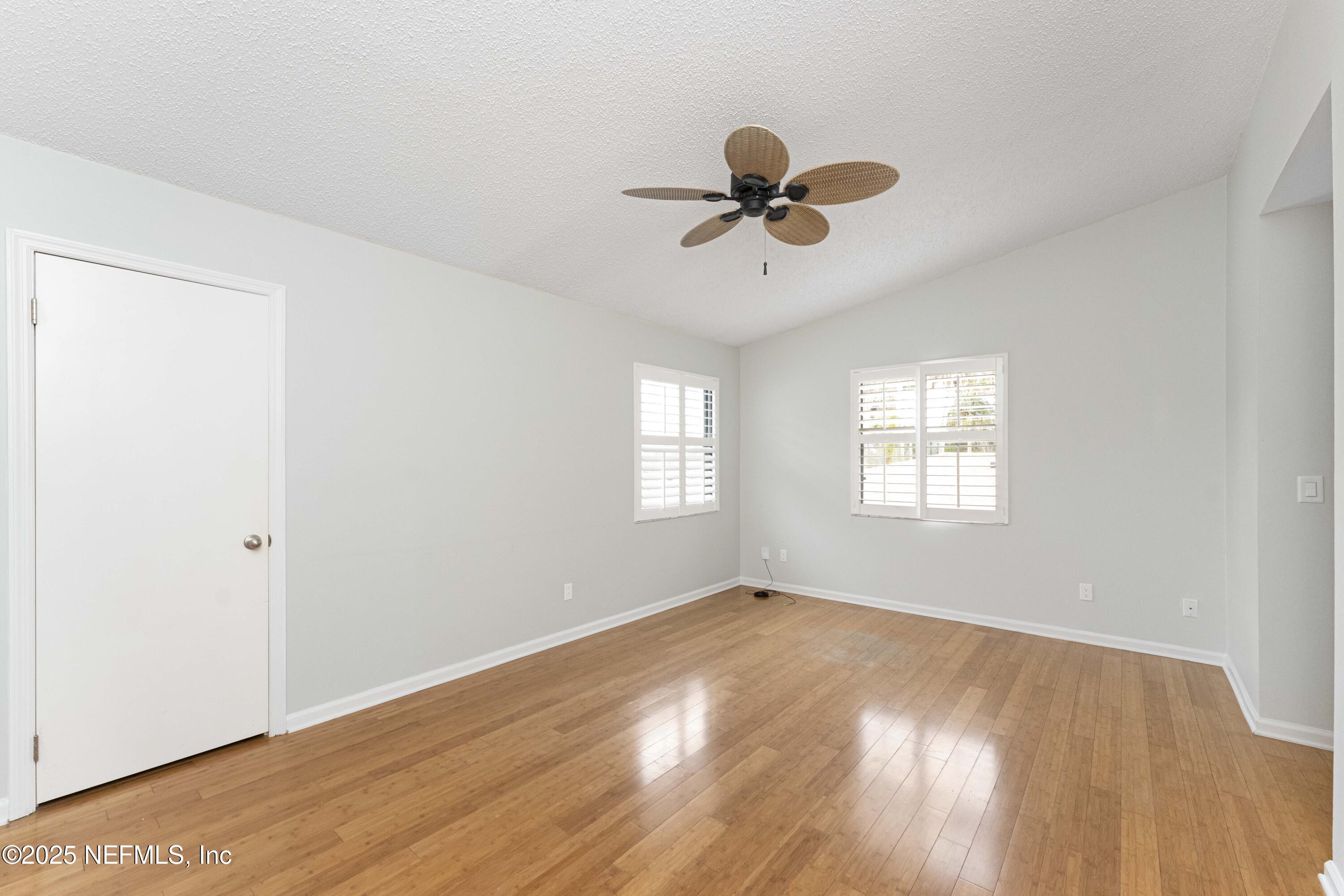 372 4th Street Atlantic Beach, FL 32233 - Photo 33 of 77 a view of empty room with wooden floor and fan