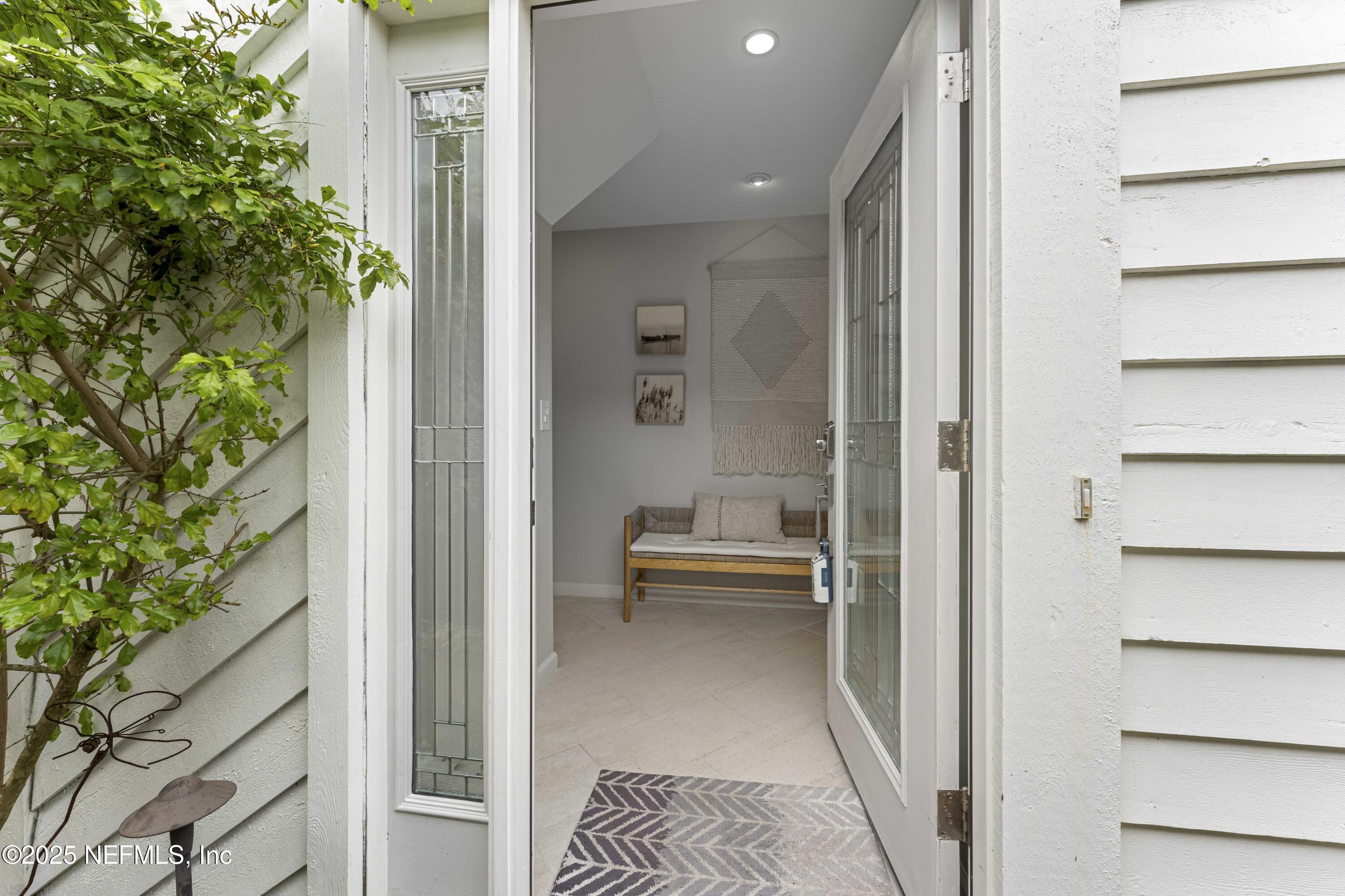 372 4th Street Atlantic Beach, FL 32233 - Photo 9 of 77 a view of a hallway with a potted plant in front of gate