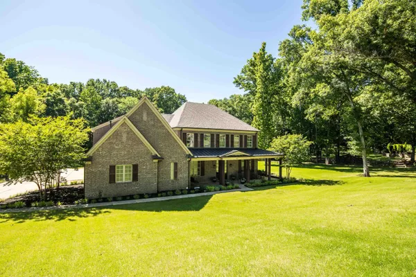 a front view of a house with a swimming pool