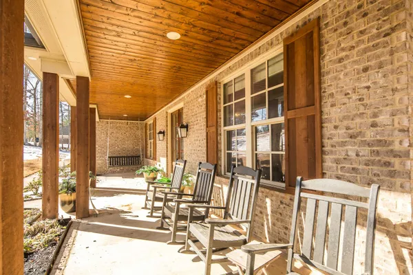 a kitchen with stainless steel appliances kitchen island granite countertop a table chairs sink and cabinets