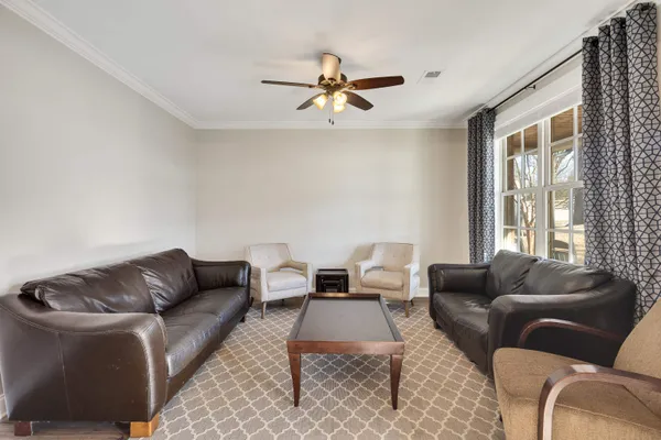 a living room with furniture and a large window