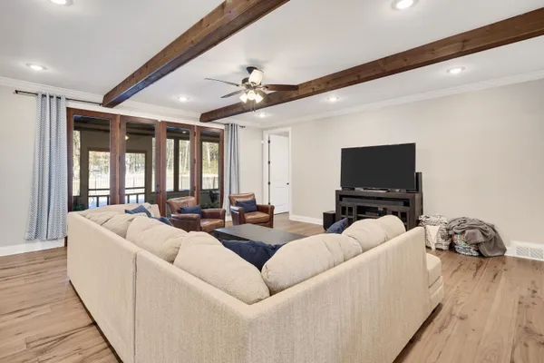 a living room with furniture and a floor to ceiling window