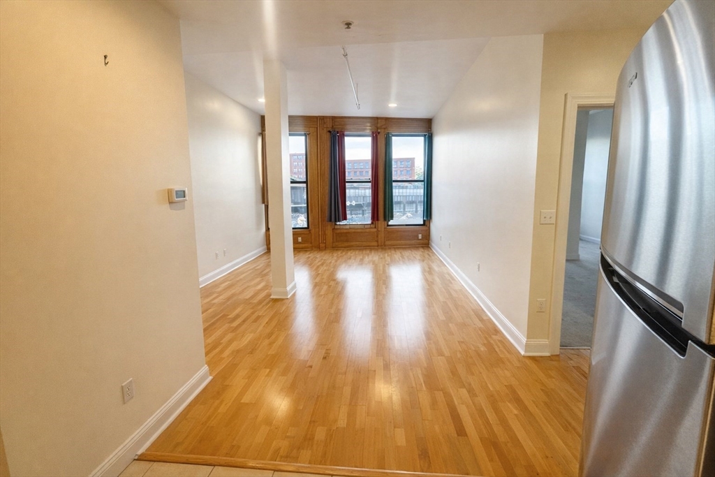 a view of hallway with wooden floor