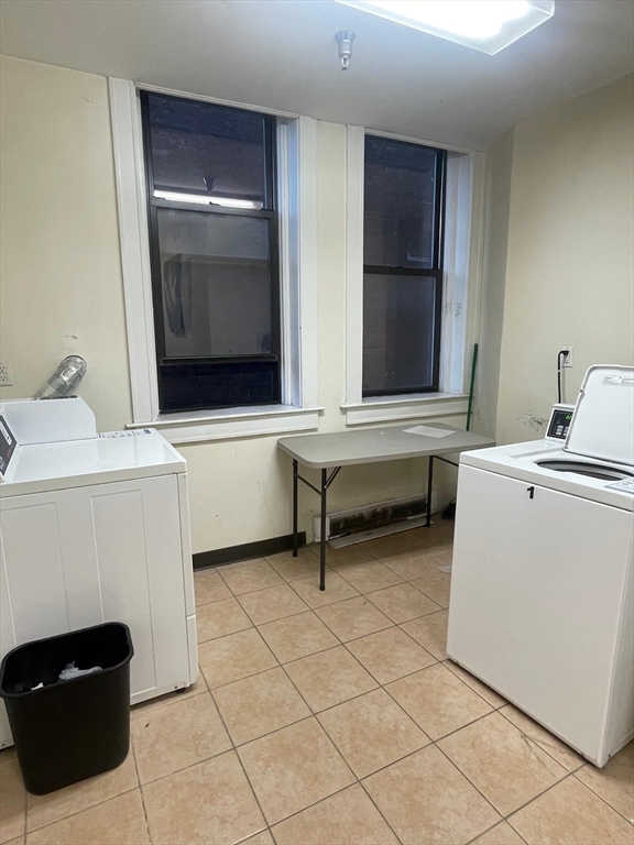 7 Central Square, Unit 203 Lynn, MA 01901 - Photo 12 of 13 a living room with a table chairs and dryer