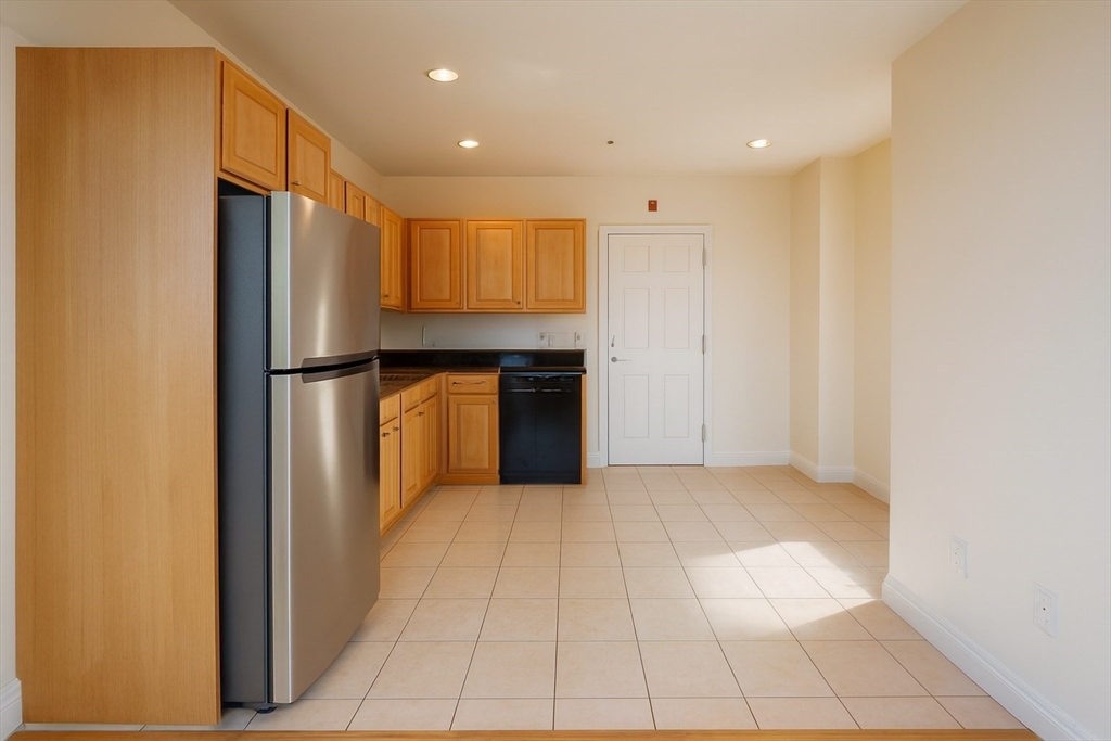 7 Central Square, Unit 203 Lynn, MA 01901 - Photo 2 of 10 a view of a kitchen with a refrigerator and a sink