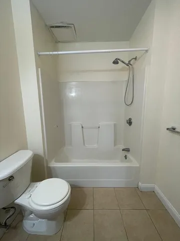 a bathroom with a toilet and shower