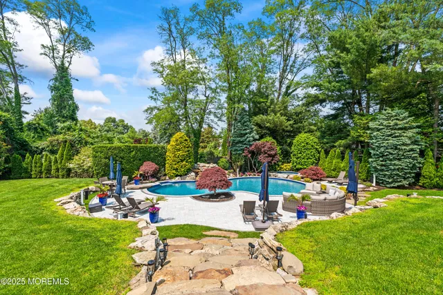 a view of a table and chairs in backyard of the house