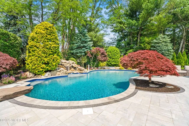 a view of a backyard with sitting area and a garden