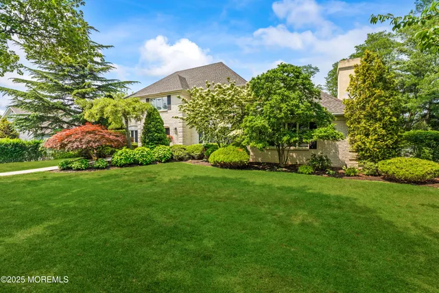 a bathroom with a double vanity sink toilet and a mirror