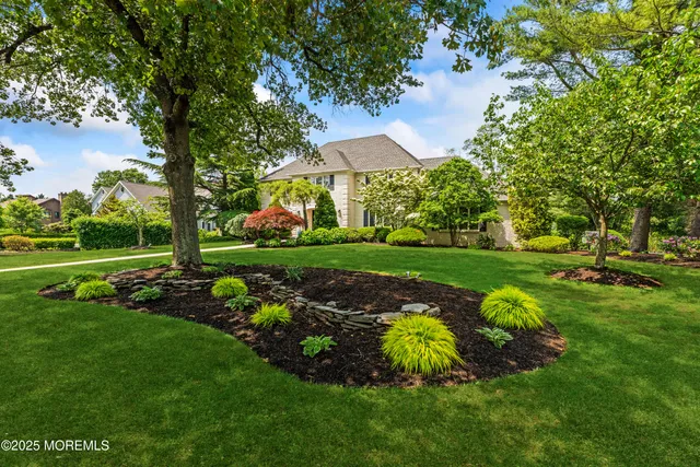 a view of a hallway with wooden floor and stairs