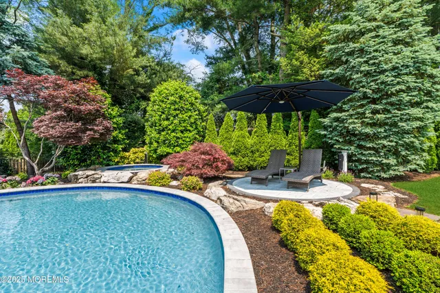 a view of a chair and fire pit in the backyard of a house