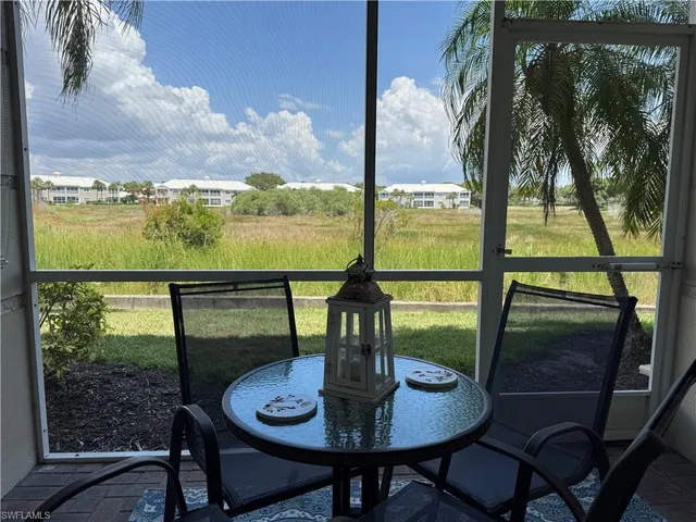 a view of a balcony with table and chairs