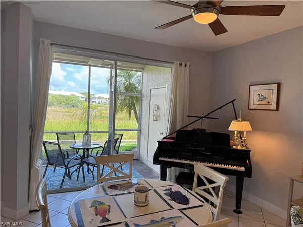 a living room with a stove and a large window