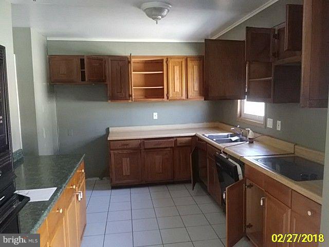 13028 Oliver Beach Road Baltimore, MD 21220 - Photo 13 of 21 a kitchen with a stove sink and cabinets