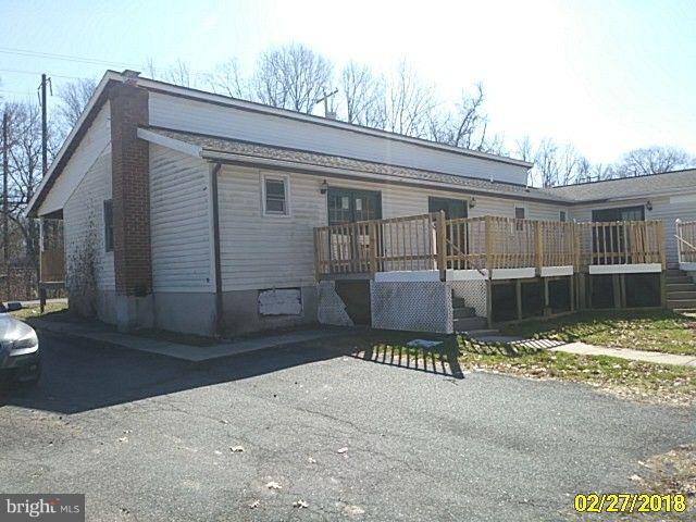 13028 Oliver Beach Road Baltimore, MD 21220 - Photo 4 of 21 a front view of a house with a yard