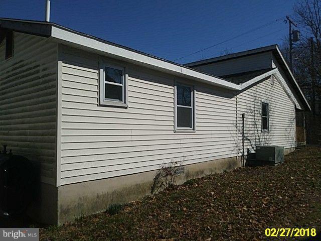 13028 Oliver Beach Road Baltimore, MD 21220 - Photo 5 of 21 a view of a house with a yard