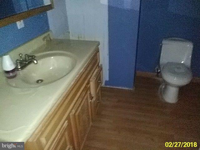 13028 Oliver Beach Road Baltimore, MD 21220 - Photo 9 of 21 a bathroom with a sink and a toilet