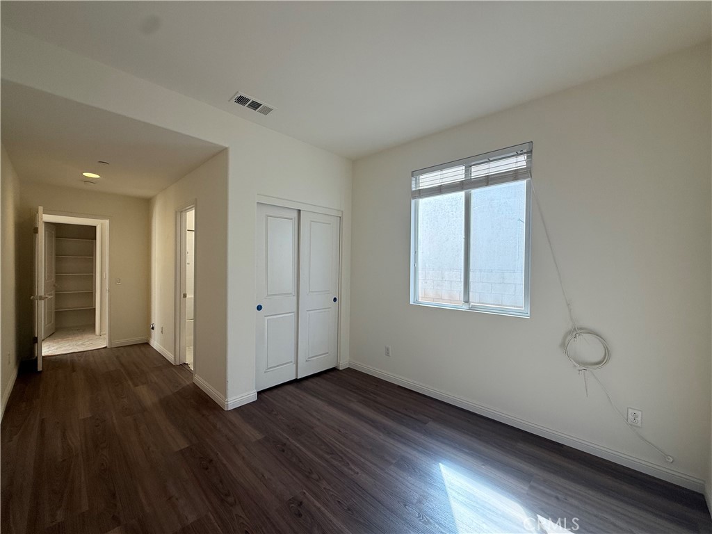 12319 Twin Gables Drive Chino, CA 91710 - Photo 11 of 42 a view of an empty room with wooden floor and a window