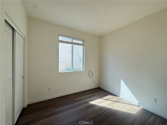 a view of an empty room and wooden floor