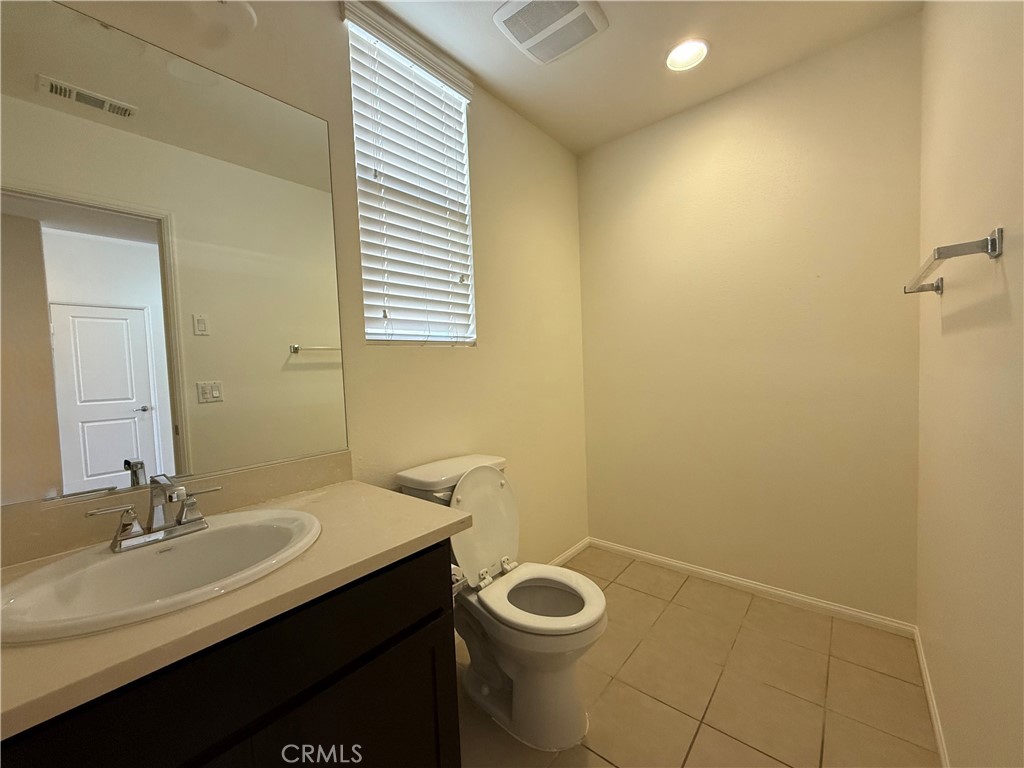 12319 Twin Gables Drive Chino, CA 91710 - Photo 13 of 42 a bathroom with a sink a toilet and a mirror