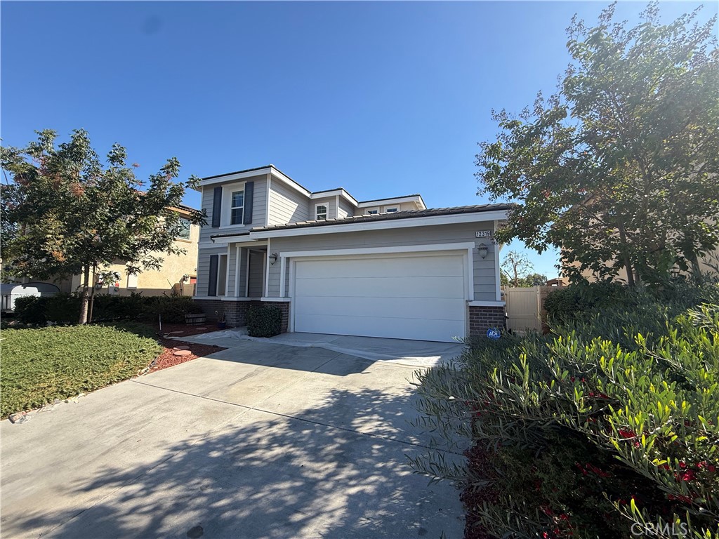 12319 Twin Gables Drive Chino, CA 91710 - Photo 2 of 42 a front view of a house with a yard and garage