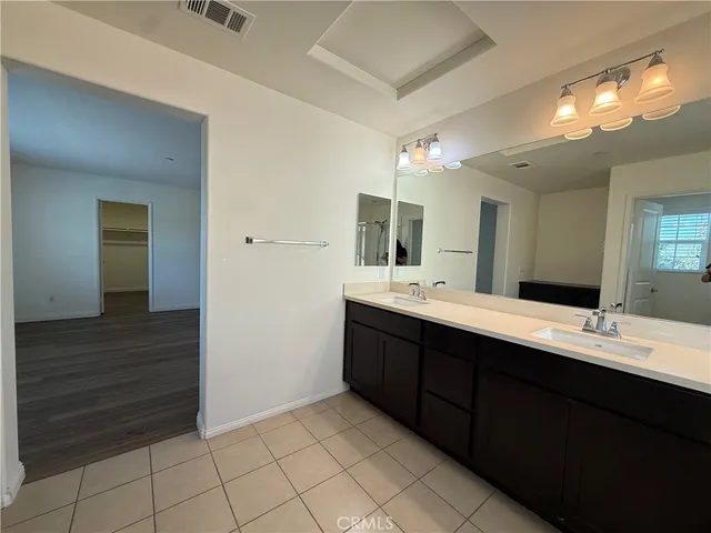 a bathroom with a sink vanity and mirror