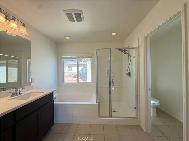 a bathroom with a tub shower vanity and a sink