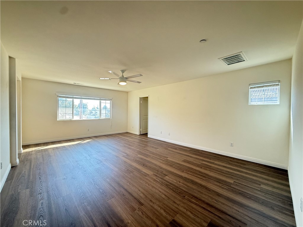 12319 Twin Gables Drive Chino, CA 91710 - Photo 29 of 42 an empty room with wooden floor and windows