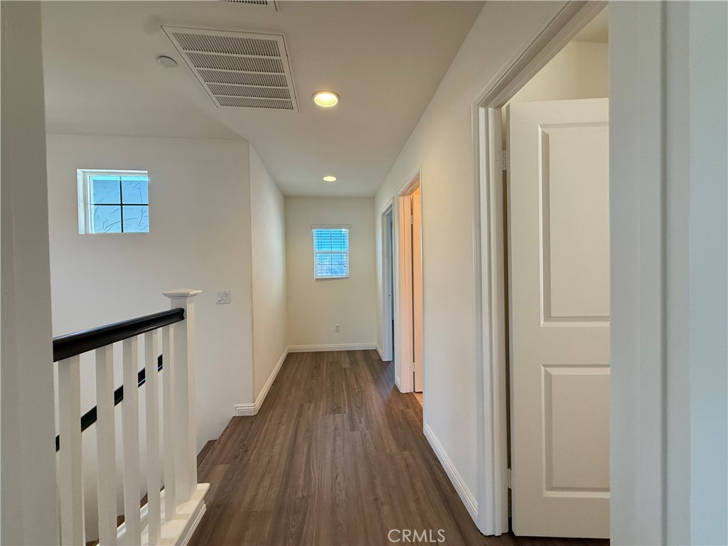 12319 Twin Gables Drive Chino, CA 91710 - Photo 33 of 42 a view of a hallway with wooden floor and staircase