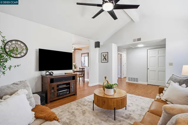 a kitchen with stainless steel appliances refrigerator dining table and chairs