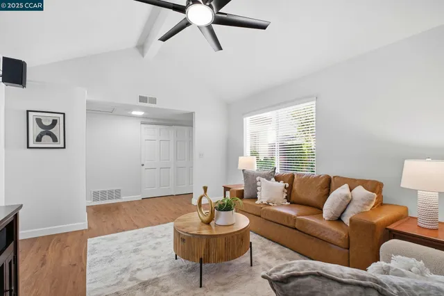a dining room with furniture a chandelier and wooden floor