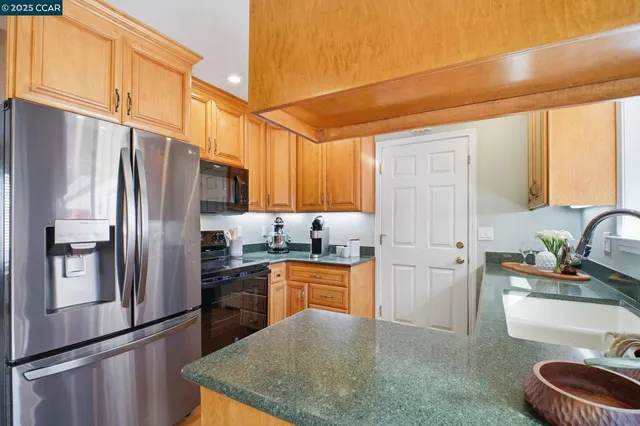 a view of a dining room with furniture wooden floor and a chandelier