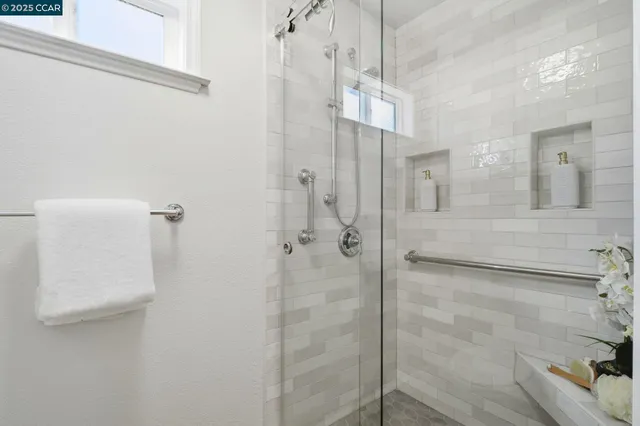 a view of a house with a small yard and large tree