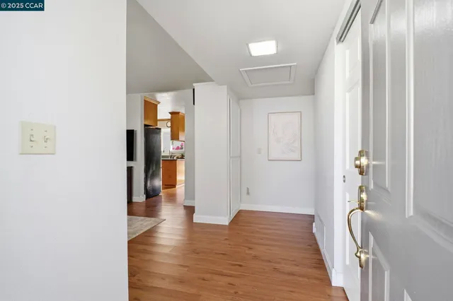 a kitchen with stainless steel appliances granite countertop a refrigerator a stove a sink and a cabinets