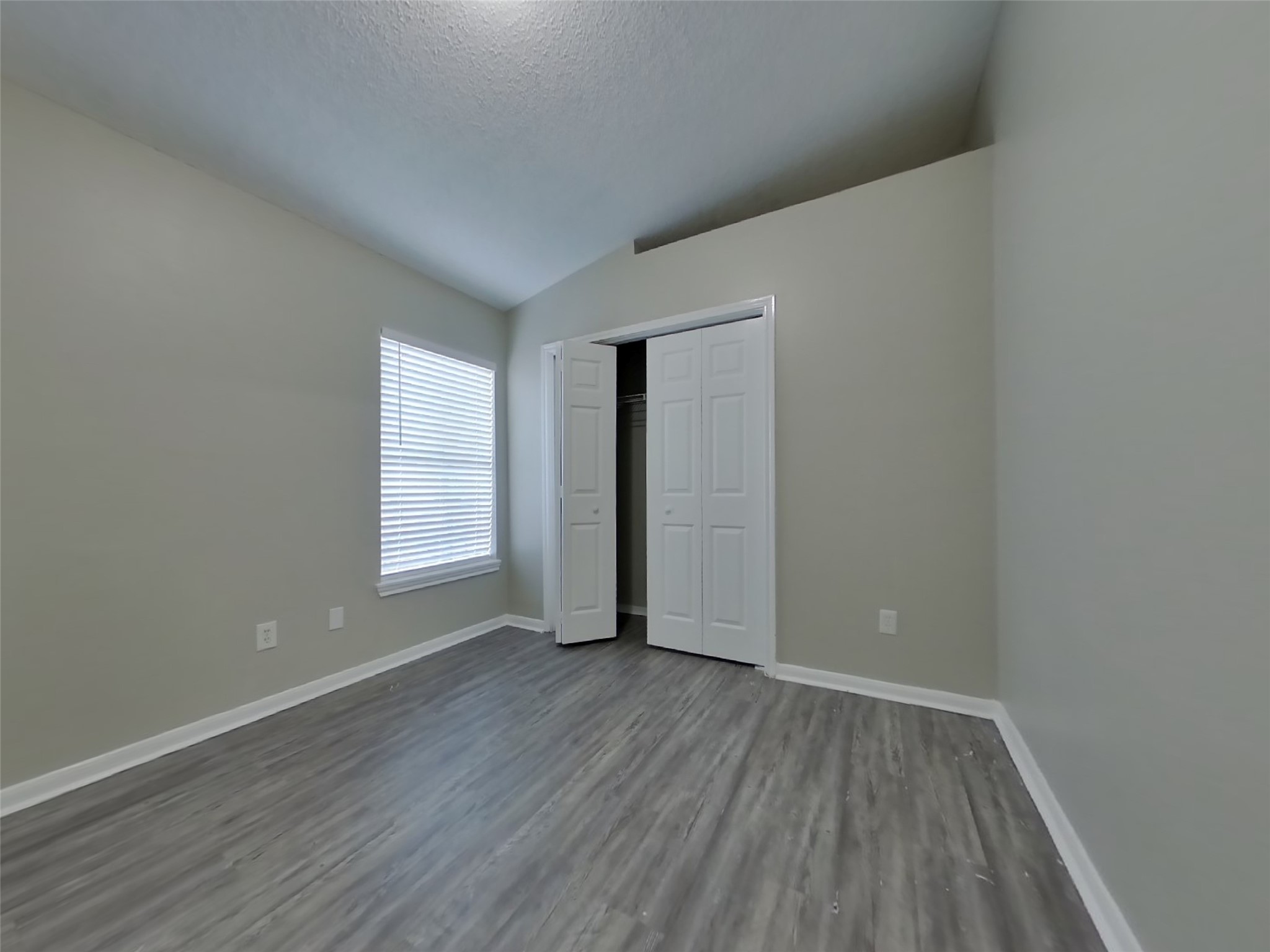 3151 Kelling Street Houston, TX 77045 - Photo 11 of 16 a view of an empty room with wooden floor and a window