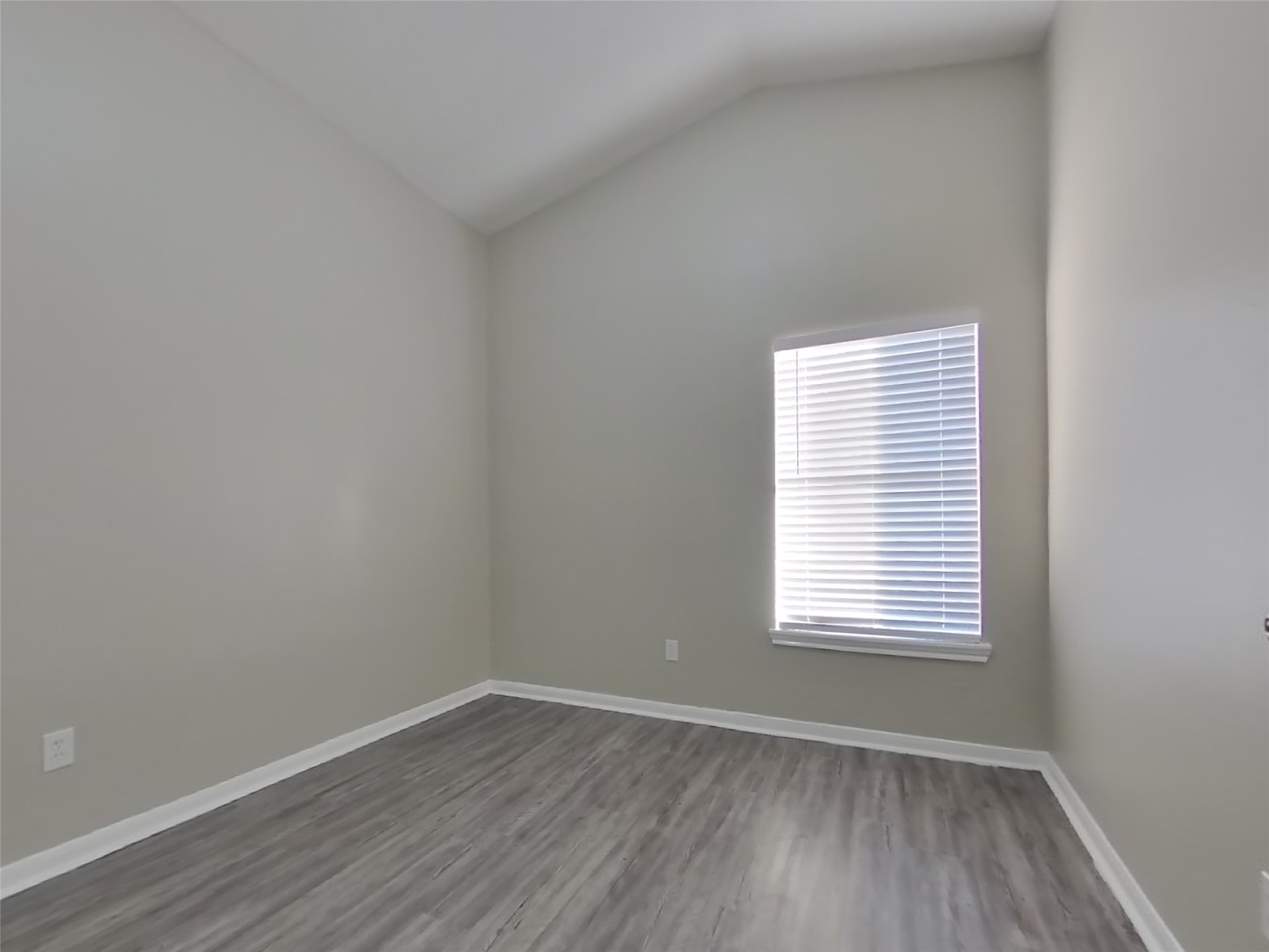 3151 Kelling Street Houston, TX 77045 - Photo 13 of 16 a view of an empty room with wooden floor and a window