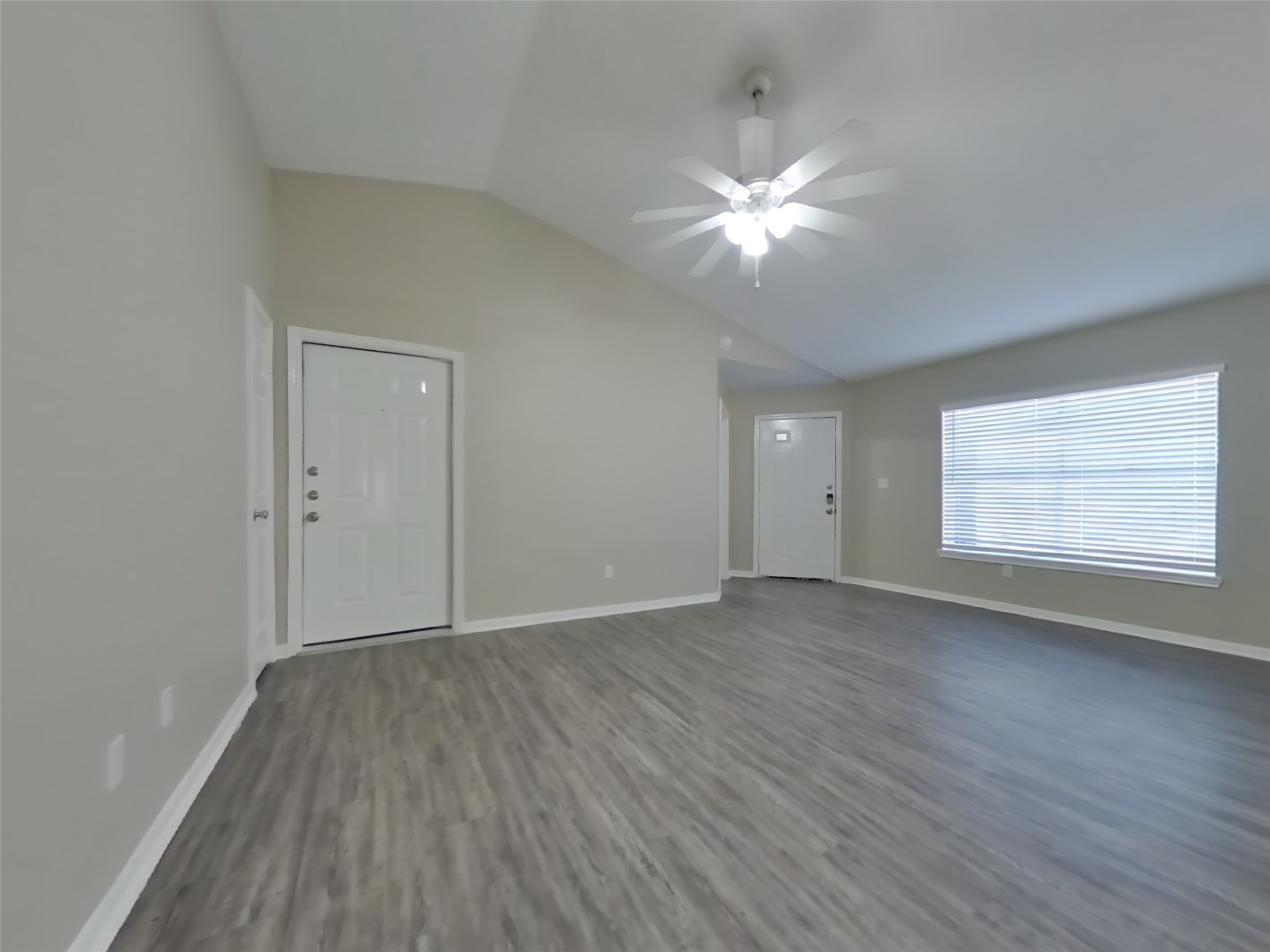 3151 Kelling Street Houston, TX 77045 - Photo 3 of 16 a view of an empty room with wooden floor and a window