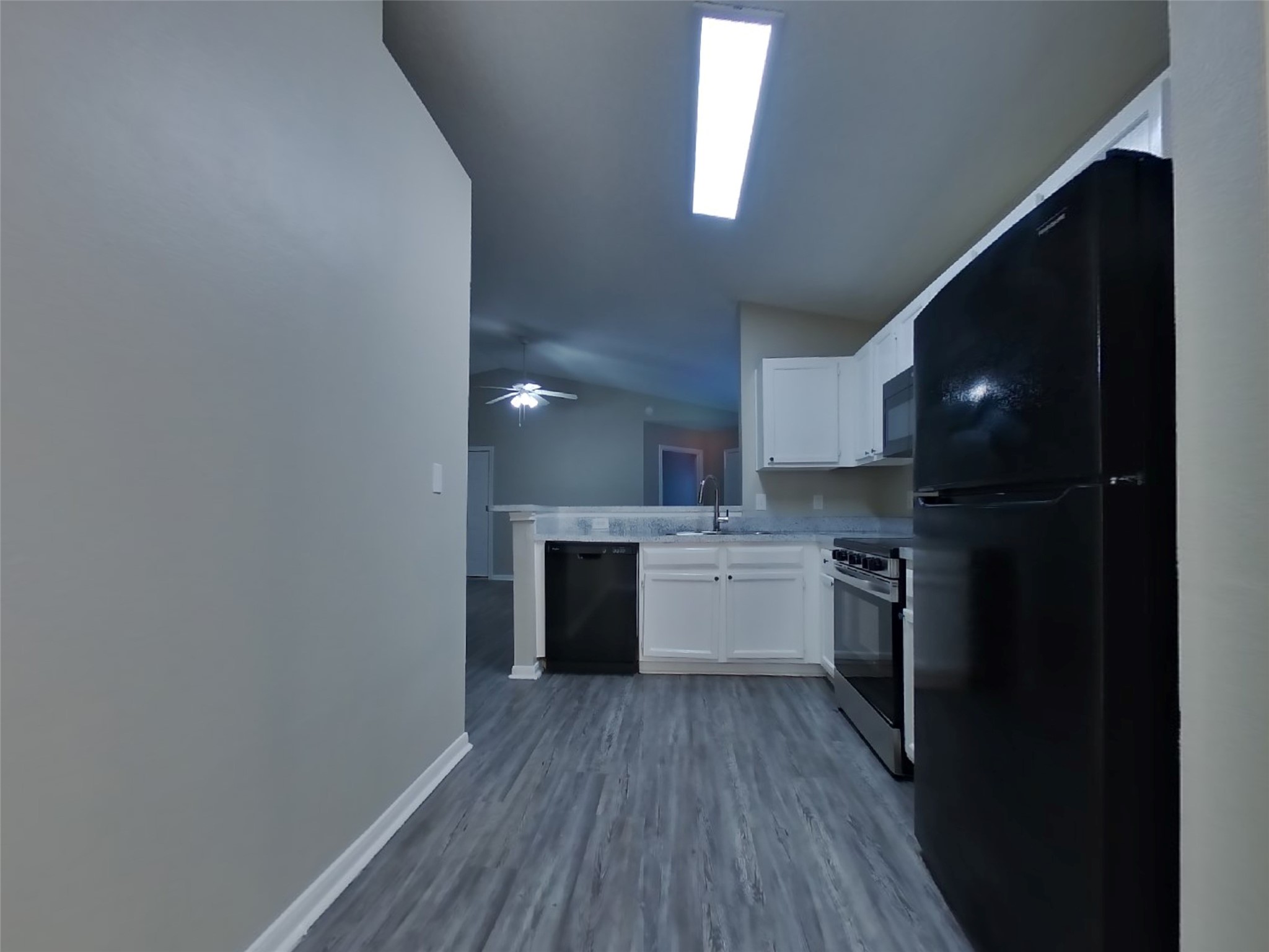 3151 Kelling Street Houston, TX 77045 - Photo 6 of 16 a kitchen with a refrigerator and a stove top oven