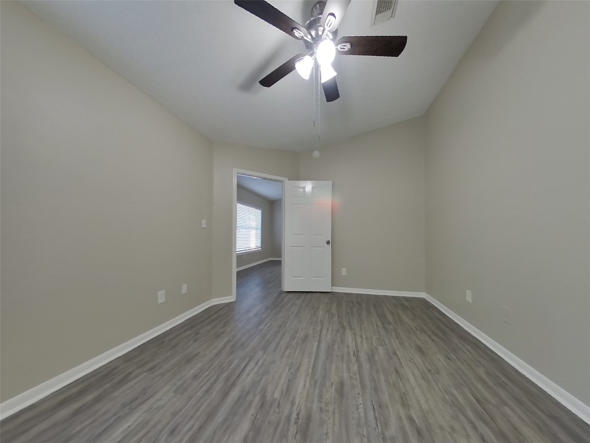 3151 Kelling Street Houston, TX 77045 - Photo 7 of 16 an empty room with a window and wooden floor