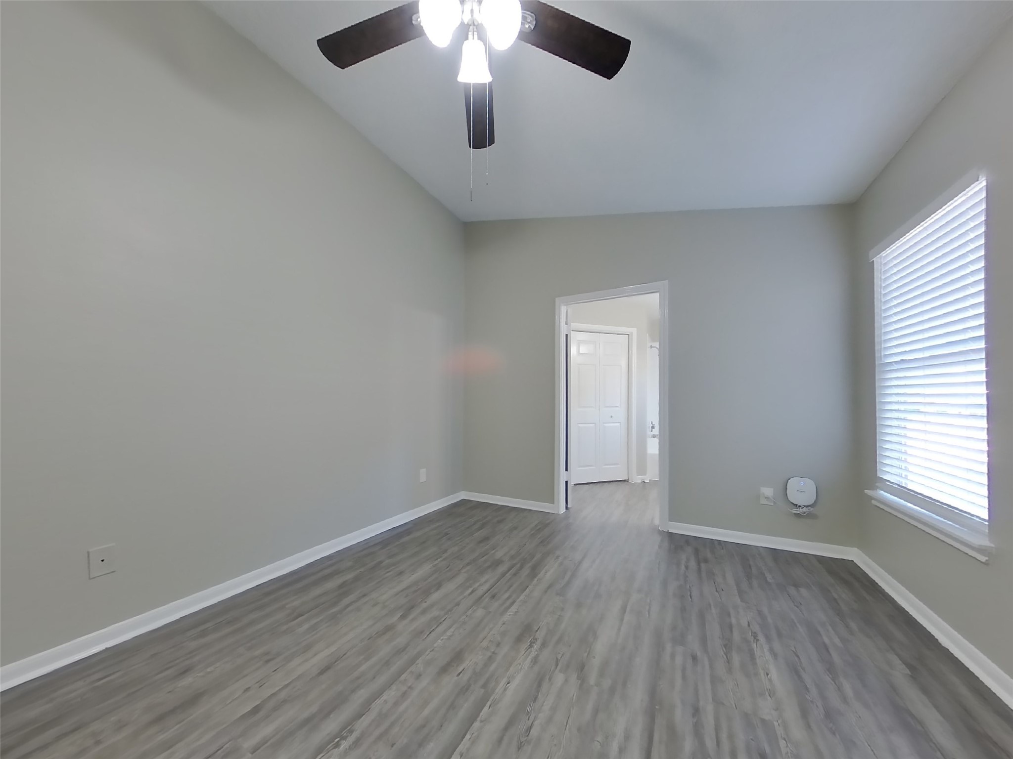 3151 Kelling Street Houston, TX 77045 - Photo 8 of 16 an empty room with wooden floor and windows