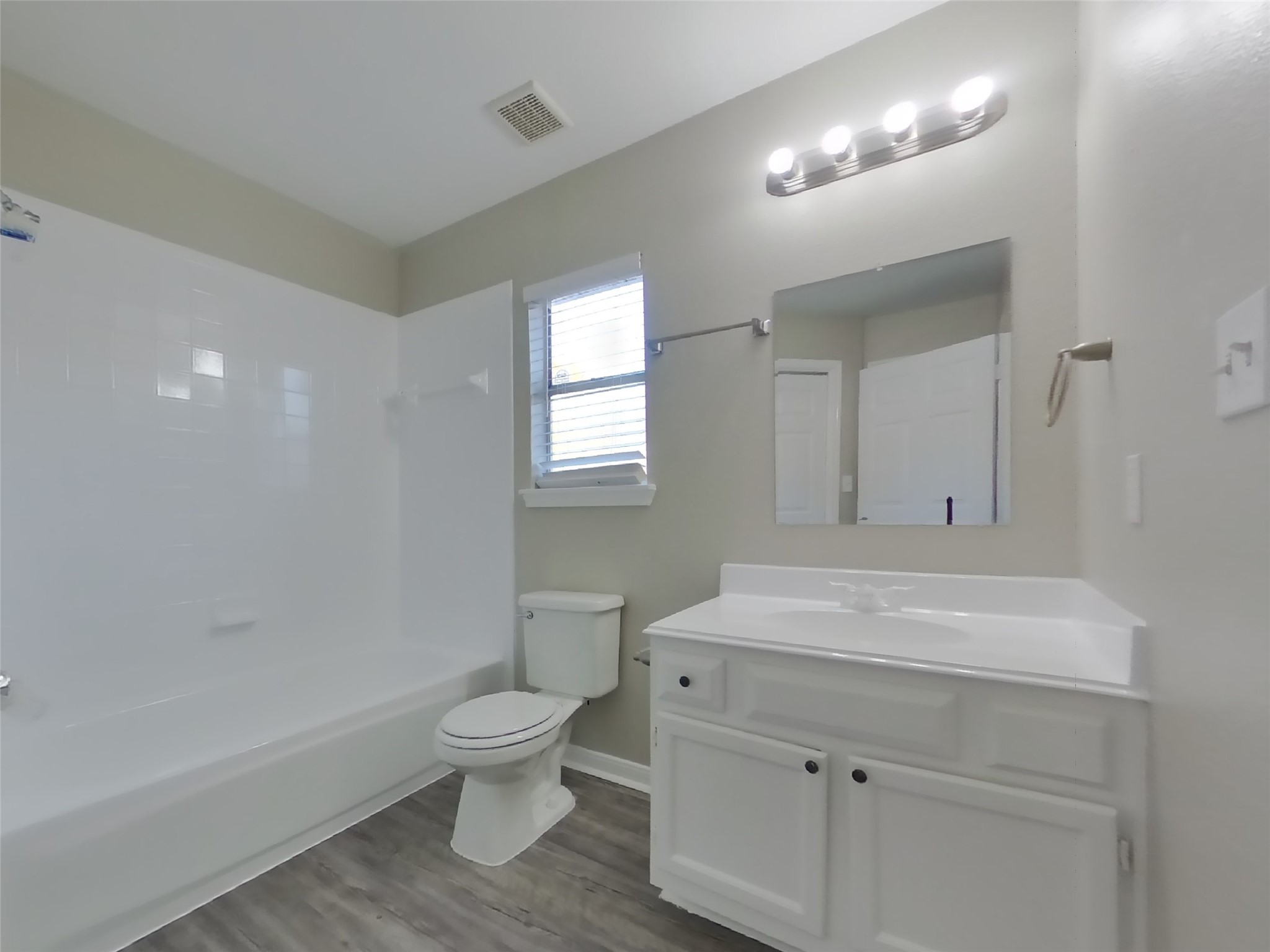 3151 Kelling Street Houston, TX 77045 - Photo 9 of 16 a bathroom with a sink a toilet and a mirror