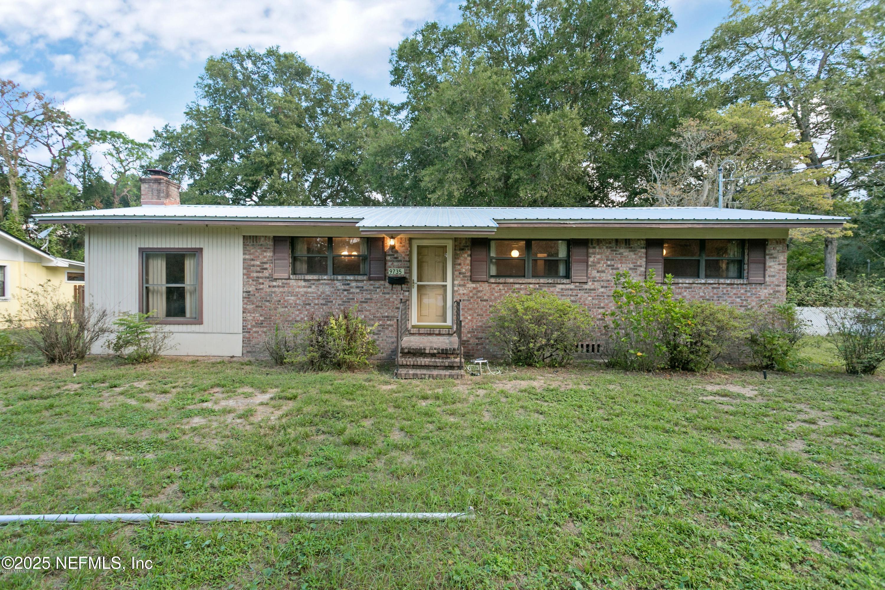 9735 Doolittle Road Jacksonville, FL 32246 - Photo 3 of 3 a view of a house with a yard
