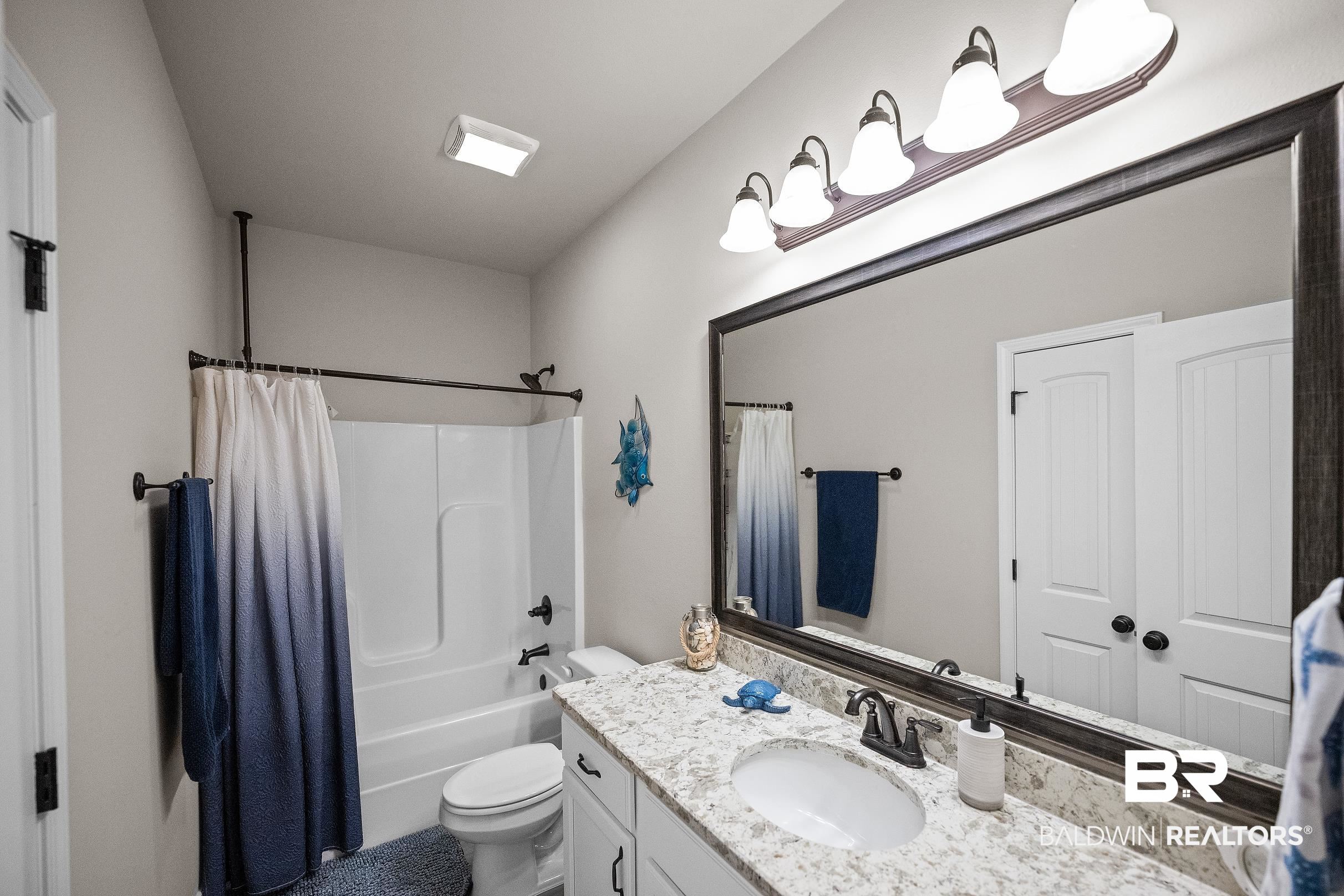 1077 Stella Road Foley, AL 36535 - Photo 17 of 27 Bathroom with vanity and shower / bath combo with shower curtain