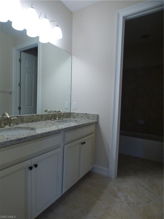 16325 Aberdeen Way Naples, FL 34110 - Photo 15 of 24 a bathroom with a granite countertop sink and a mirror