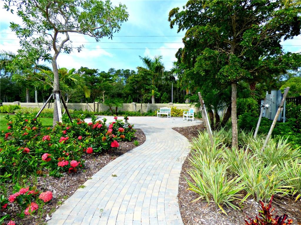 16325 Aberdeen Way Naples, FL 34110 - Photo 21 of 24 a view of a garden with flowers and trees